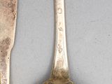 two spoons and a spoon on a table