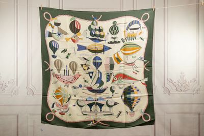 a green and white wall hanging with a picture of hot air balloons