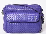 a purple cross body bag on a white background