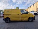a yellow van parked in a parking lot next to a building