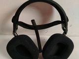 a pair of black headphones sitting on a white surface