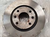 a close up of a metal disc on a plastic bag