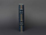 an old blue book sitting on top of a gray table