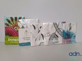 three boxes of tissues sitting on a table next to each other