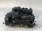 an image of a black train engine sitting on top of a white surface