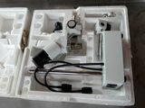 a white box with a microscope and other items in it