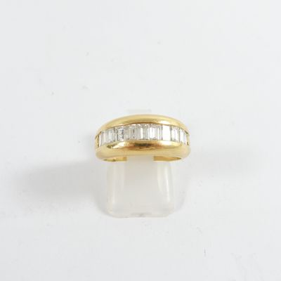 a yellow gold ring with baguets of diamonds