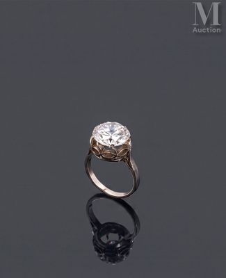 an image of a diamond ring on a black surface