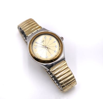 an image of a gold and silver watch on a white surface