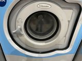 a close up of a washing machine with the door open