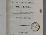 an open book with a stamp on it sitting on a table