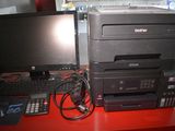 a desktop computer and a printer on a red desk