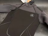 a wetsuit with a tag on it laying on the floor