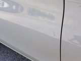 a close up of a car door with a reflection on it