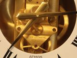 a gold clock with roman numerals on the face of it