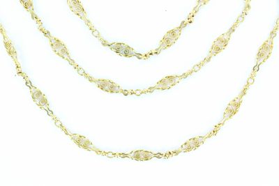 a close up of a gold chain necklace on a white background