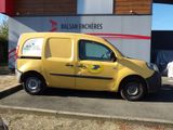 une petite camionnette jaune garée devant un immeuble