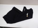 the top of a pair of black pants with gold buttons on them