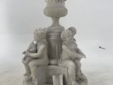 a statue of two children sitting on a pedestal