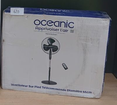 a box with a fan on the table next to a box with a remote
