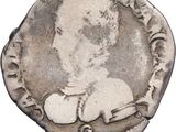 une pièce d'argent sur laquelle figure l'image d'un homme