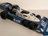 a blue and white race car that is on a table