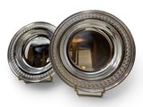 pair of silver plated dishes on stand on white background