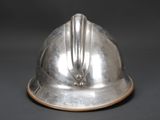 a silver helmet that is sitting on a table