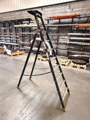 a ladder that is leaning against a wall in a warehouse