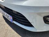 a close up of a white car with a license plate on it