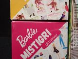 two boxes of barbies that are on a table