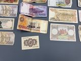 a lot of different bank notes on the table