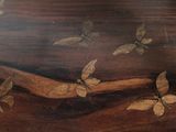 many butterflies that are flying around on a wooden table