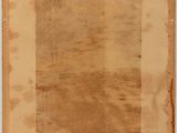 an old piece of paper with writing on it sitting on top of a table