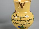 a small yellow vase with a poem on it