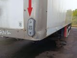 a white truck with a red arrow on the back of it