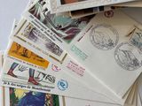 a pile of stamps and envelopes on a table