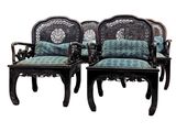 pair of carved wood chairs with blue and green upholstered cushions