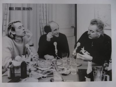 photographie en noir et blanc d'un groupe de personnes assises autour d'une table