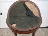 a small round table with a green cloth on top of it