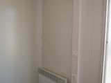 a small room with a heater in the corner of the room