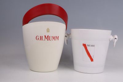 a white bucket with a red handle next to a white bucket with a red handle