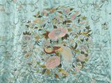 a close up of a blue and pink floral embroidered fabric