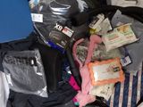 a bag full of clothes and a laptop on a bed