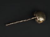 a close up of a metal object on a black surface