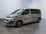 the silver van is parked in a room with a white wall