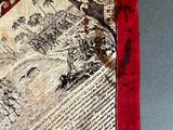 a red and white scarf with a picture of a man riding a horse