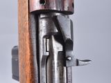 a close up of a gun with a wooden handle