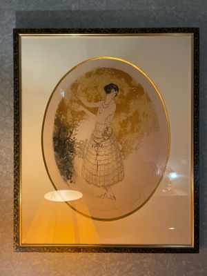 a picture of a woman in a dress on the wall