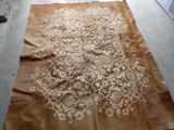 a brown rug with a white design on it